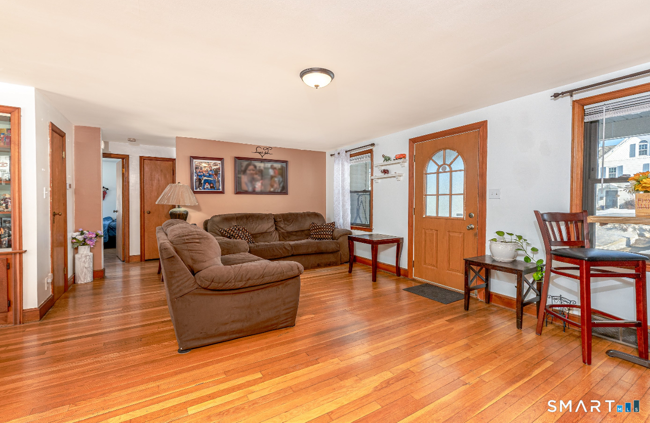 136 Pearl Lake Road Waterbury, CT 06706 - Photo 10 of 35 a living room with furniture and a wooden floor