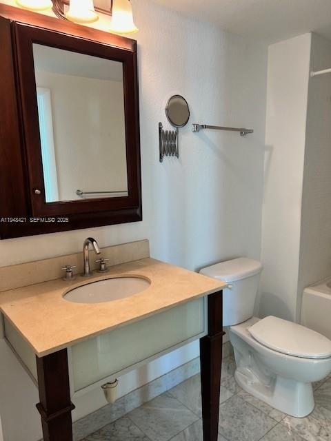 500 Northeast 29th Street, Unit 1002 Miami, FL 33137 - Photo 5 of 7 a bathroom with a sink a toilet and mirror