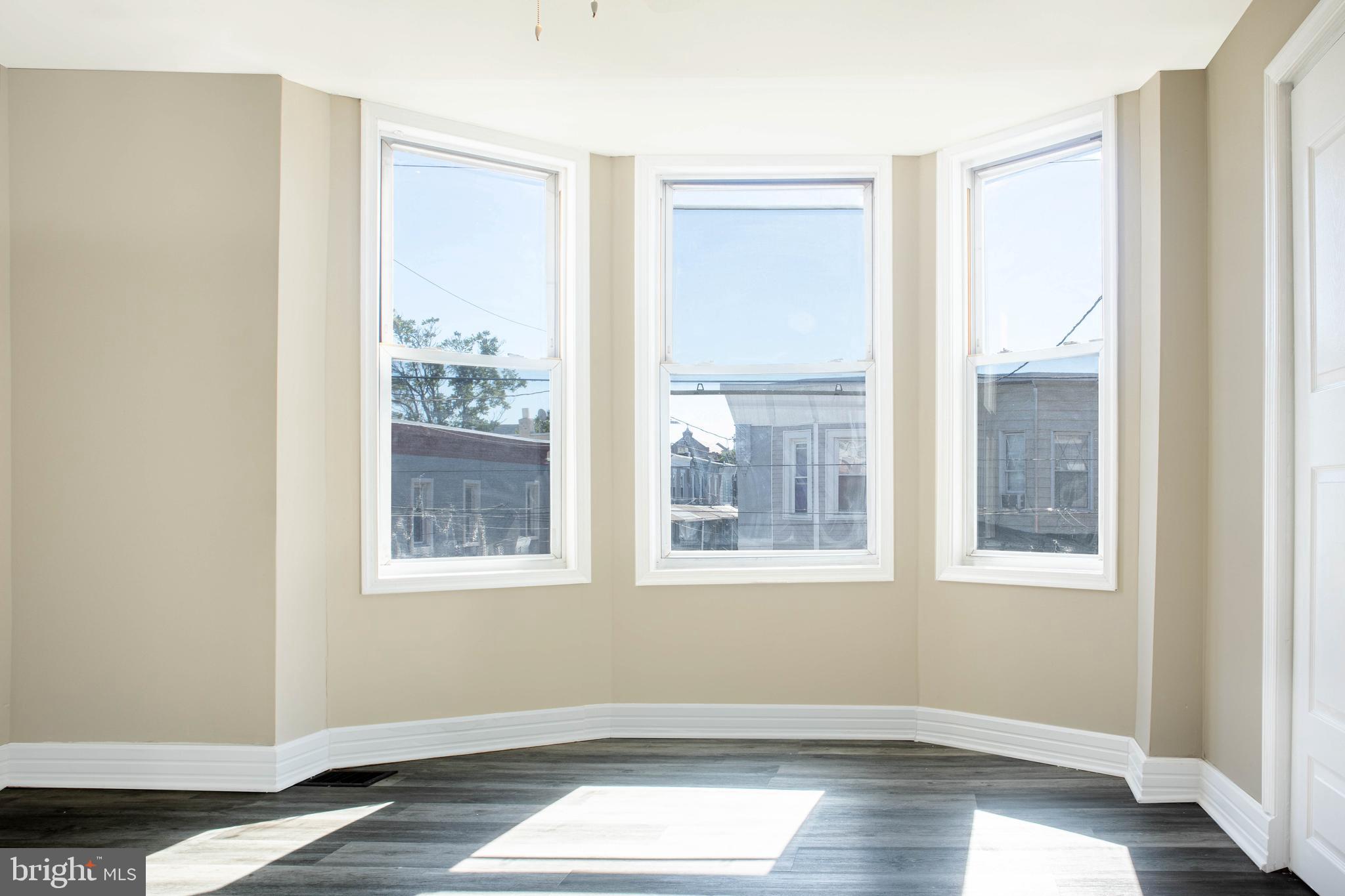 2137 Mifflin Street Philadelphia, PA 19145 - Photo 14 of 21 a view of an empty room with wooden floor and a window