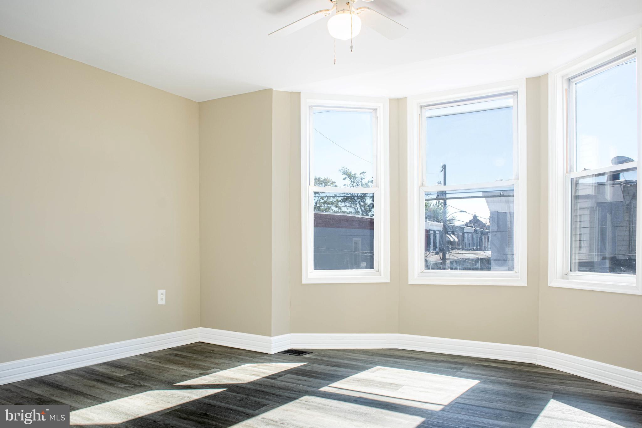 2137 Mifflin Street Philadelphia, PA 19145 - Photo 18 of 21 a view of an empty room with wooden floor and a window