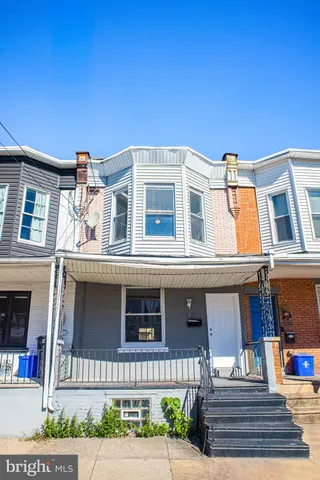 a front view of a residential apartment building with a yard