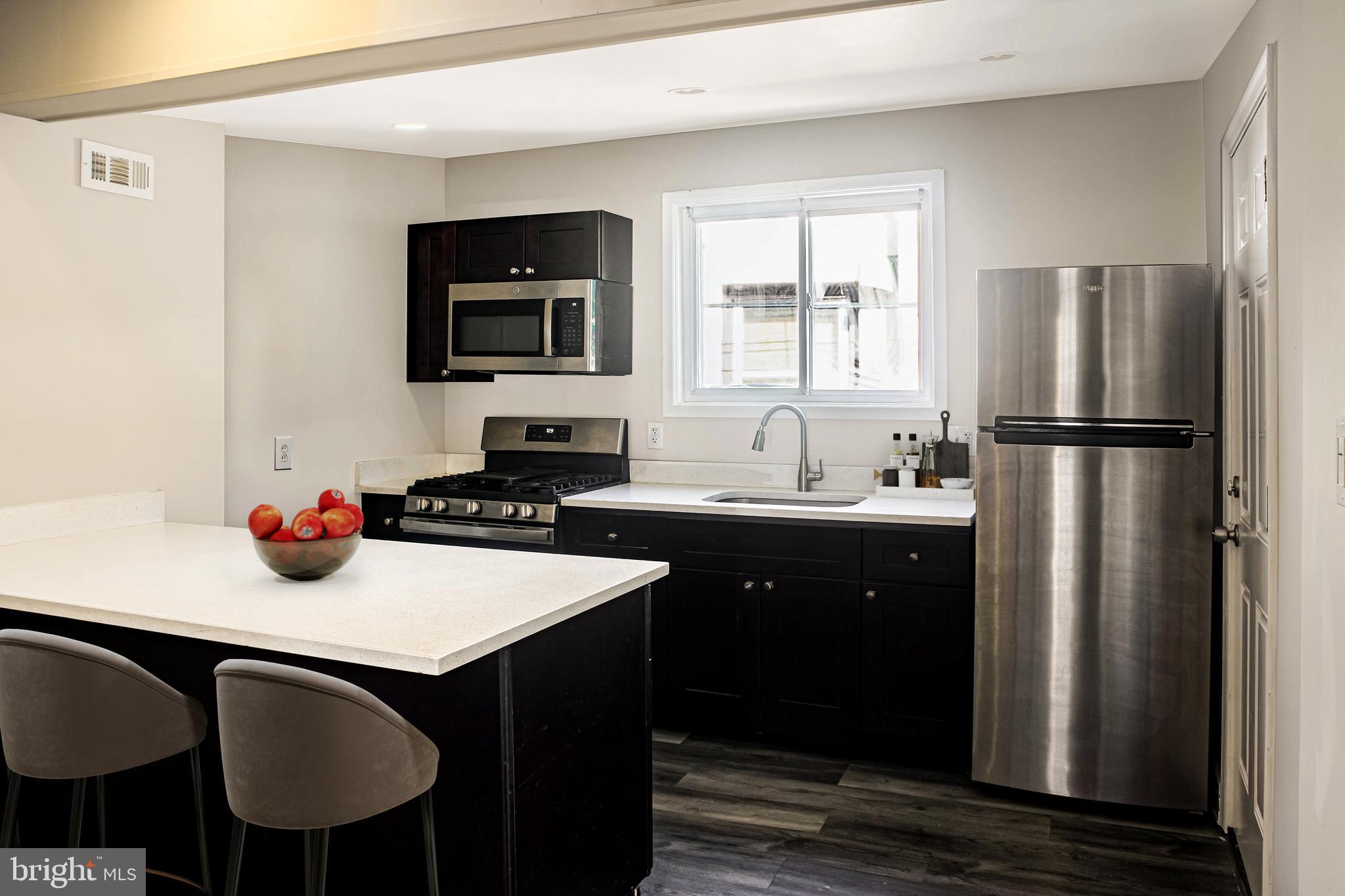 2137 Mifflin Street Philadelphia, PA 19145 - Photo 2 of 21 a kitchen with a sink a refrigerator and a stove