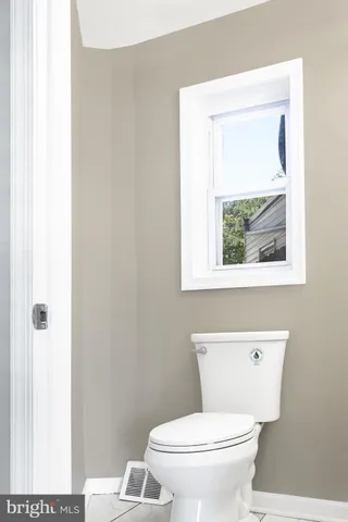 a white toilet sitting next to a bathroom sink