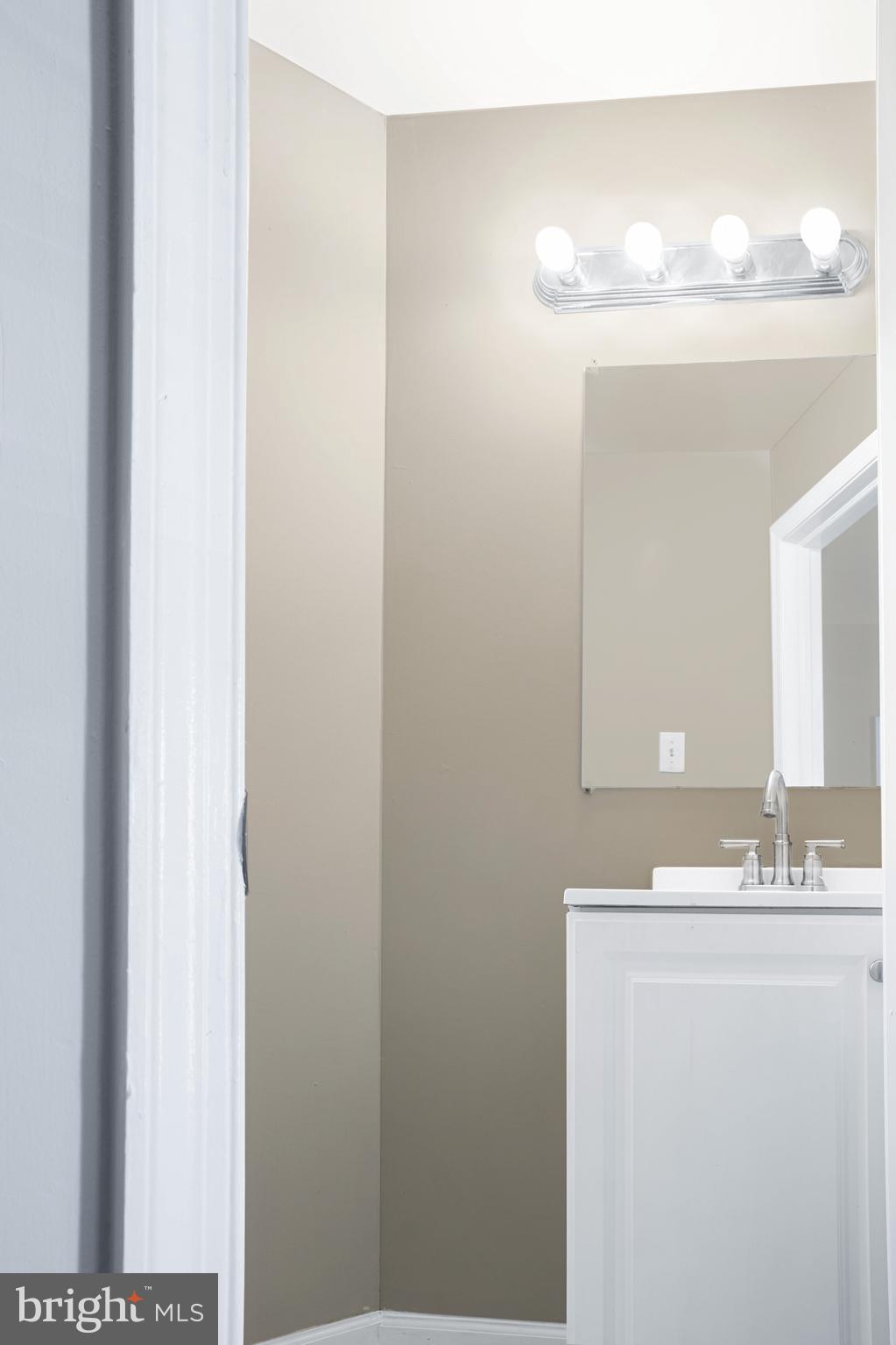 2137 Mifflin Street Philadelphia, PA 19145 - Photo 4 of 21 a bathroom with a sink and a mirror