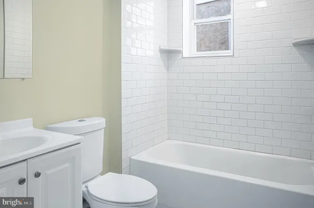 a bathroom with a sink a toilet and bathtub
