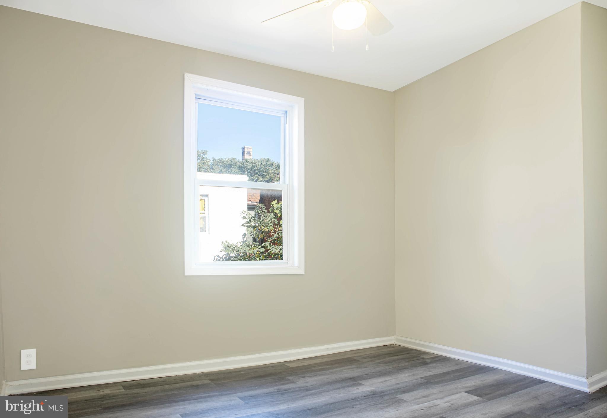 2137 Mifflin Street Philadelphia, PA 19145 - Photo 8 of 21 an empty room with wooden floor and a window