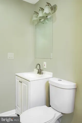 a white toilet sitting next to a bathroom sink