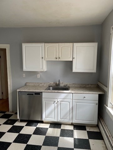 25 Wolcott Street Boston, MA 02121 - Photo 2 of 14 a kitchen with a checkered floor and cabinets