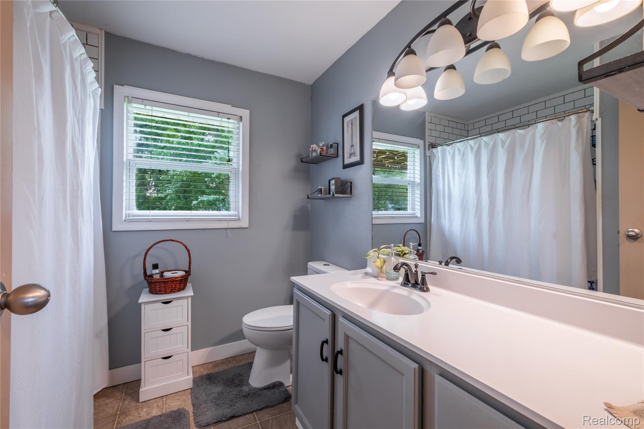 7800 Maple Street Birch Run, MI 48415 - Photo 13 of 29 Bathroom with a dual-sink vanity featuring a white countertop and gray cabinetry