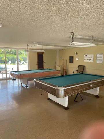 a room with pool table and chair