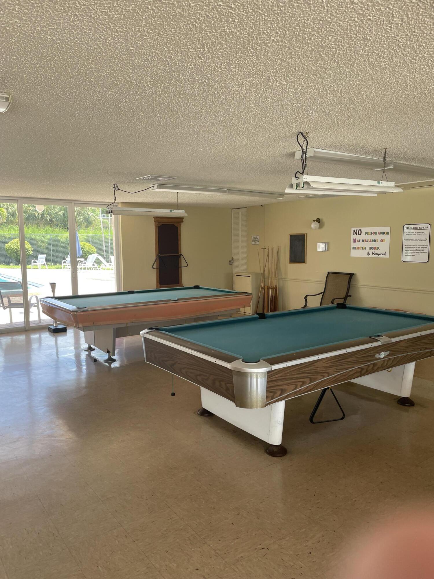 725 Lori Drive, Unit 406 Palm Springs, FL 33461 - Photo 29 of 40 a room with pool table and windows