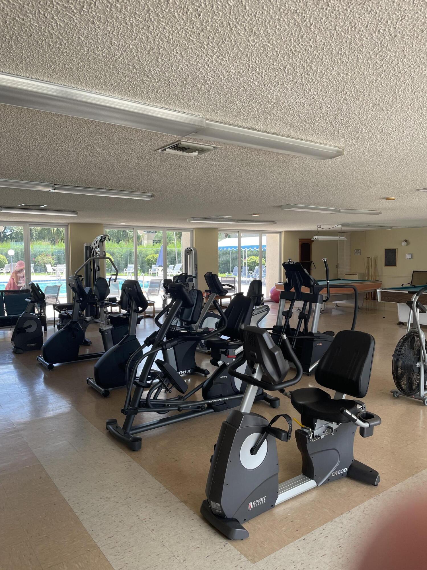 725 Lori Drive, Unit 406 Palm Springs, FL 33461 - Photo 34 of 40 a view of a room with gym equipment