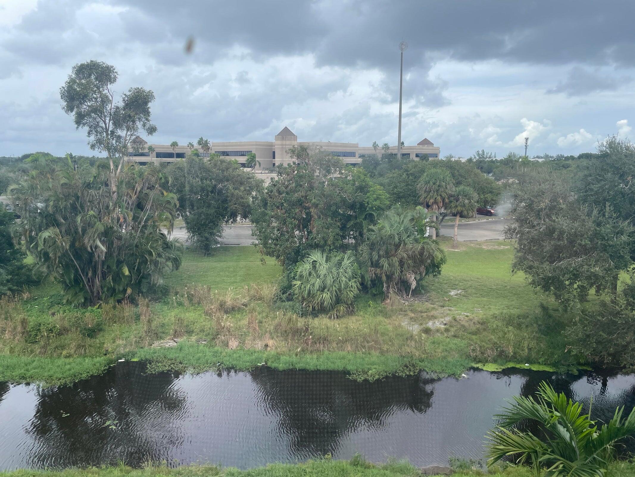725 Lori Drive, Unit 406 Palm Springs, FL 33461 - Photo 39 of 40 a view of a lake from a yard