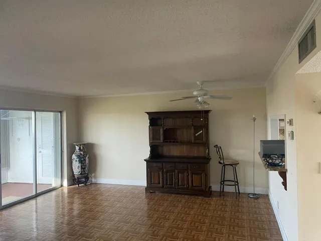 a hallway with seating and a flat screen tv