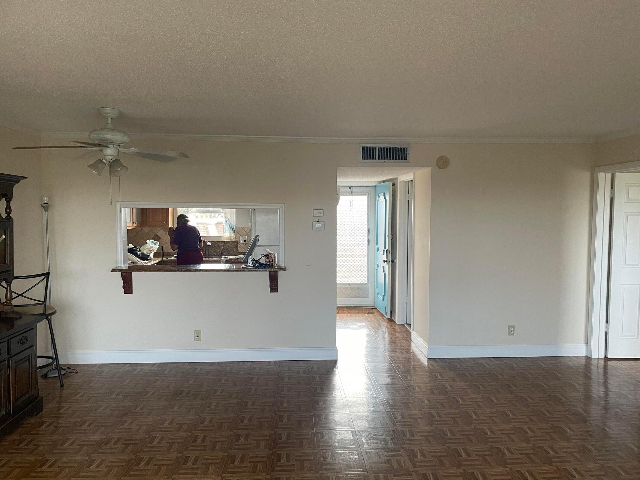 725 Lori Drive, Unit 406 Palm Springs, FL 33461 - Photo 6 of 40 an empty room with wooden floor and windows