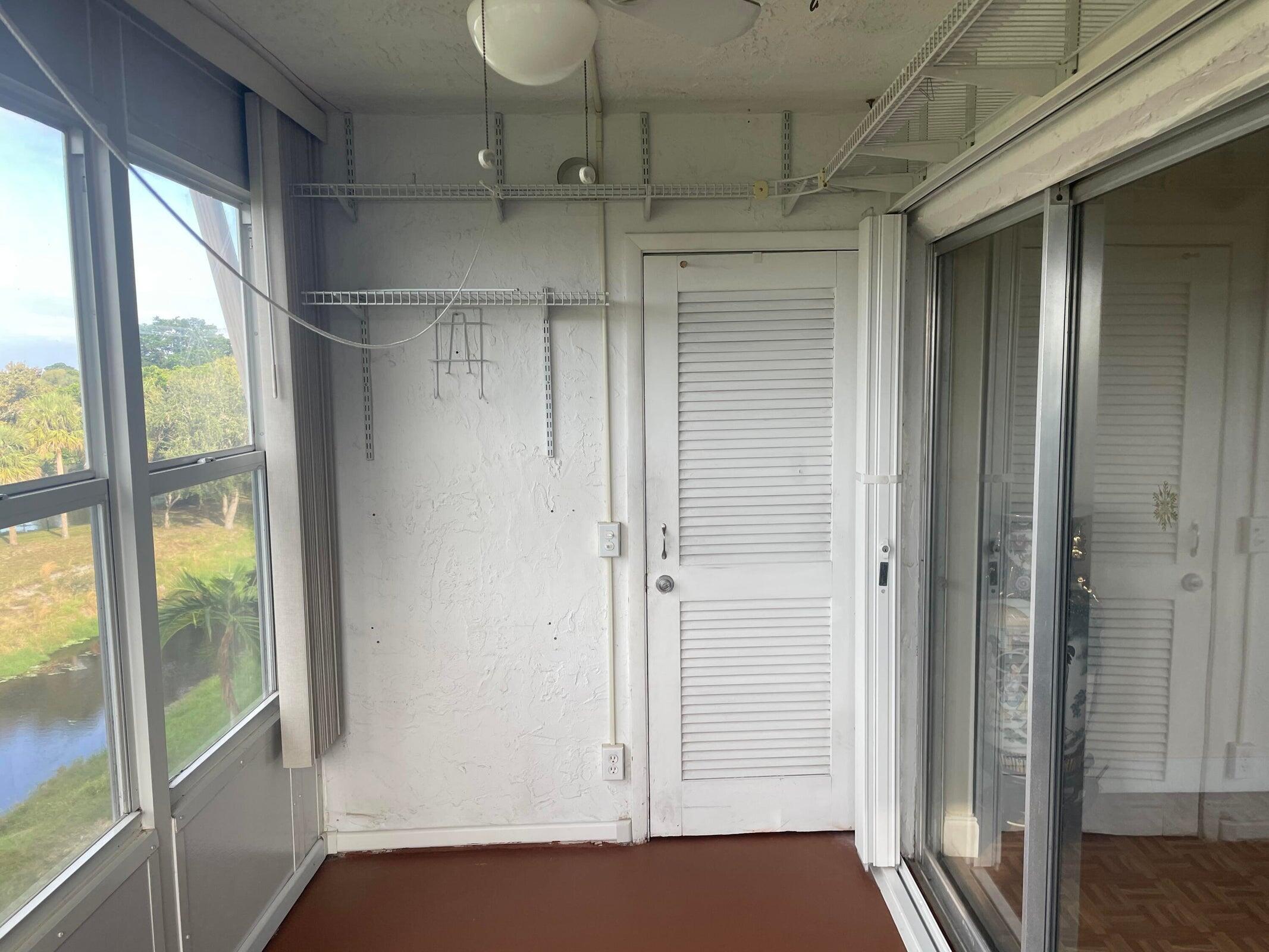 725 Lori Drive, Unit 406 Palm Springs, FL 33461 - Photo 10 of 40 a view of empty room with wooden floor and fan