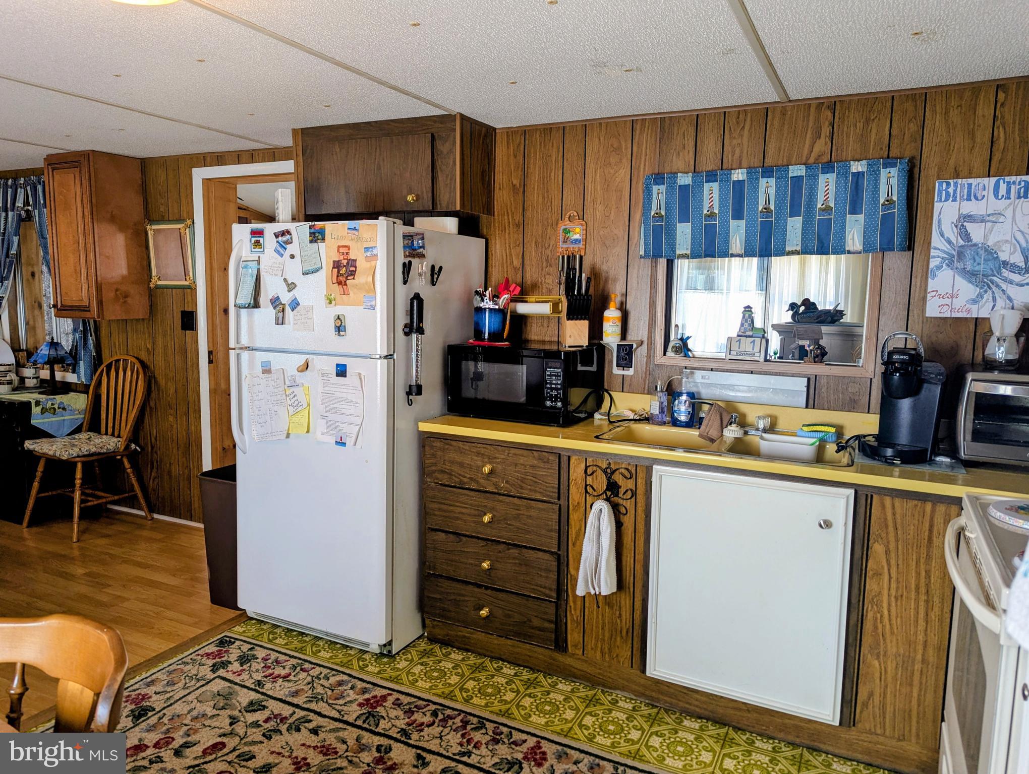 33501 Grape Street Millsboro, DE 19966 - Photo 14 of 38 a kitchen with stainless steel appliances a refrigerator and a stove top oven