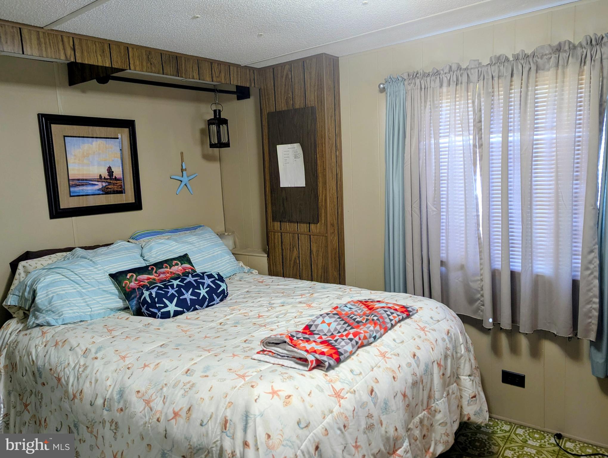33501 Grape Street Millsboro, DE 19966 - Photo 21 of 38 a bedroom with a bed and a painting on the wall