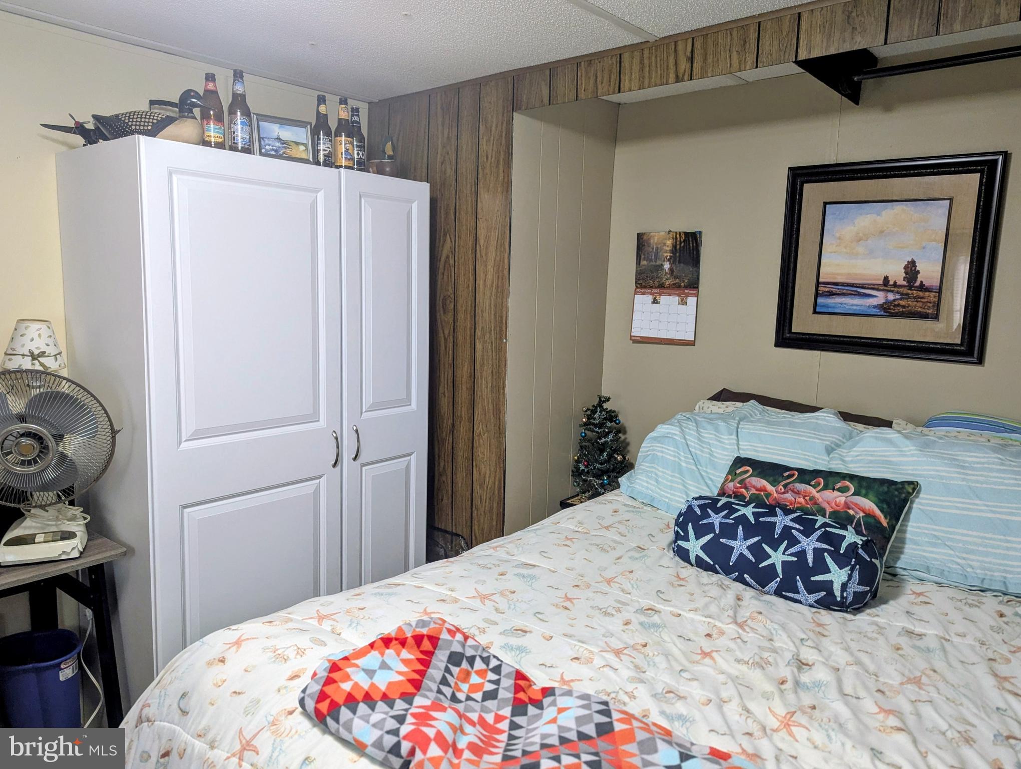 33501 Grape Street Millsboro, DE 19966 - Photo 22 of 38 a bedroom with a bed and a painting on the wall