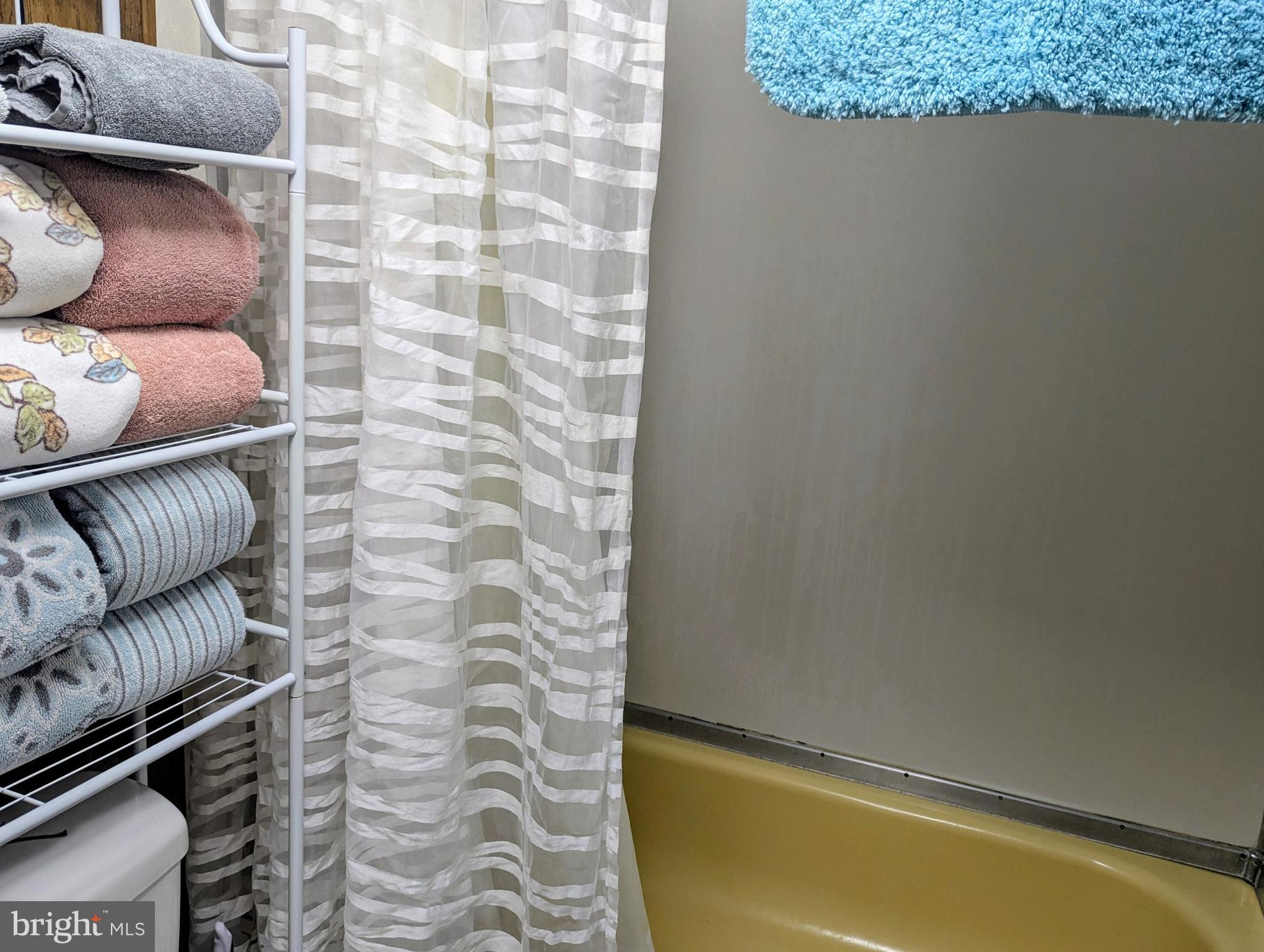 33501 Grape Street Millsboro, DE 19966 - Photo 23 of 38 a bathroom with a granite countertop bathtub and sink