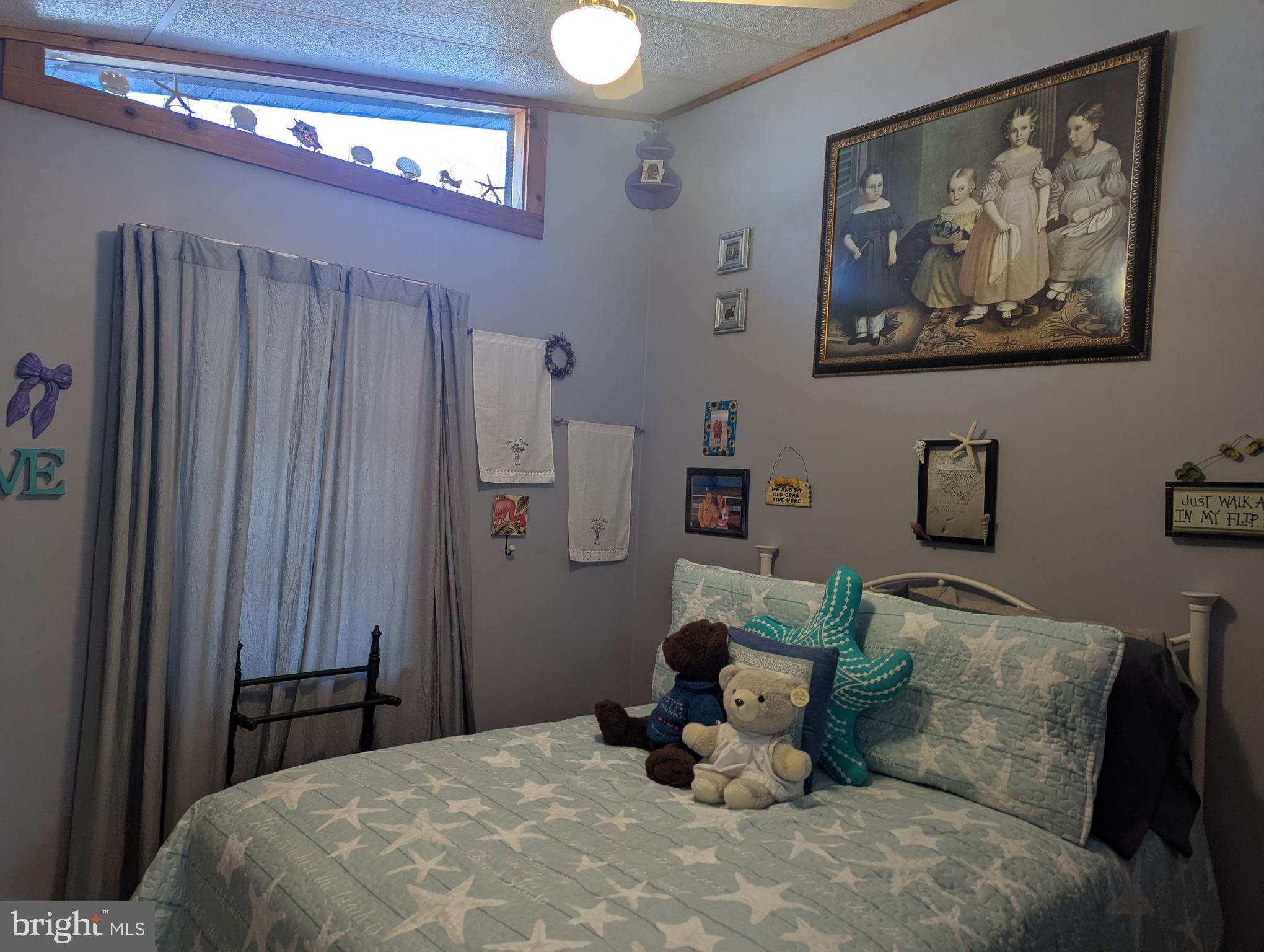 33501 Grape Street Millsboro, DE 19966 - Photo 9 of 38 a bedroom with a bed and a painting on the wall