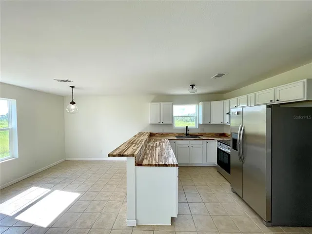 a kitchen with refrigerator and window