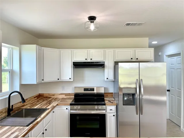 a kitchen with a refrigerator and a sink