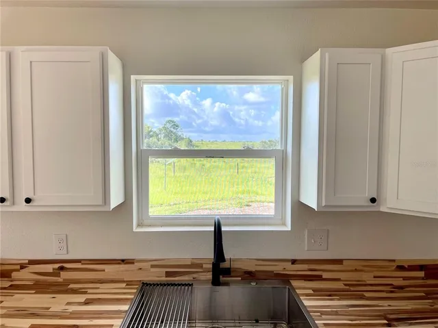 a kitchen with a window a sink and a counter top space