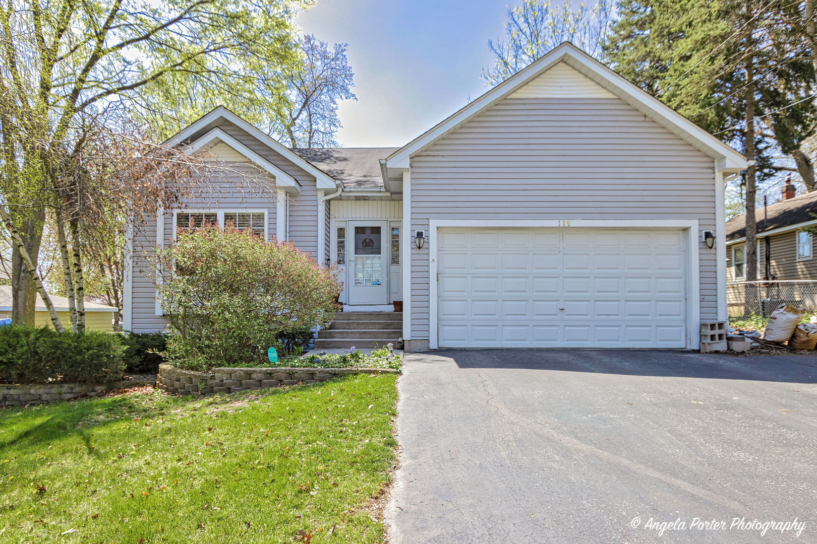 a front view of house with yard and trees around