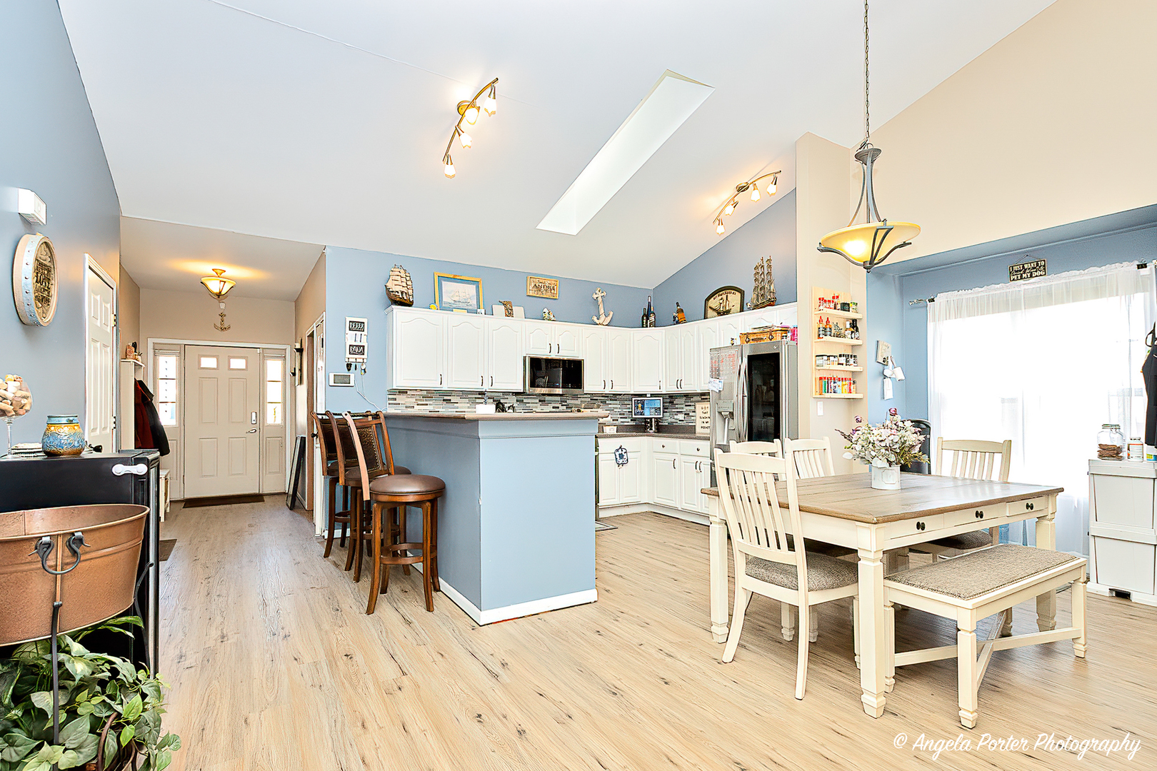 119 Eagle Point Road Fox Lake, IL 60020 - Photo 3 of 29 a dining room with stainless steel appliances kitchen island granite countertop a table chairs and a wooden floor