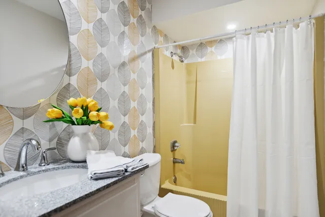 a bathroom with a sink toilet and shower