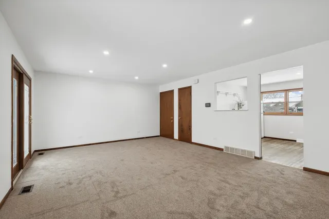 an empty room with closet and mirrors