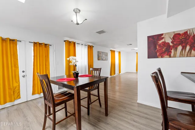 a view of a dining room with furniture and window