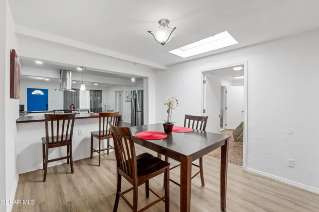 a dining room with furniture and wooden floor
