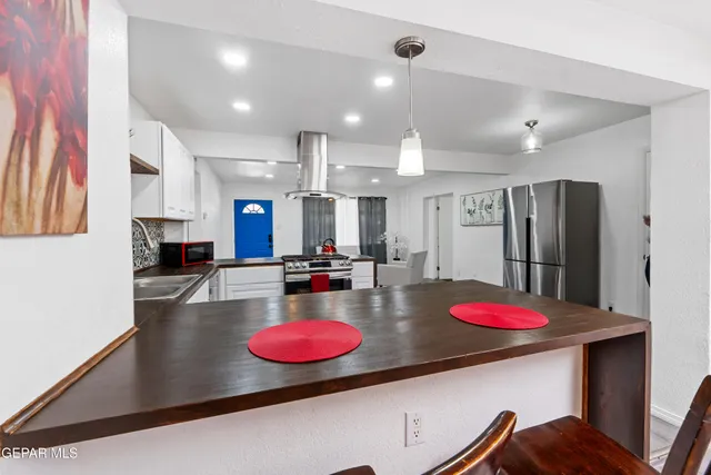a kitchen with refrigerator and stove