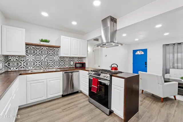 a kitchen with a sink cabinets and wooden floor