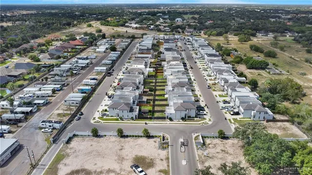 an aerial view of residential houses with outdoor space