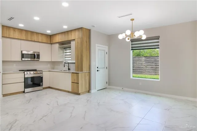 a living room with stainless steel appliances kitchen island granite countertop furniture and a kitchen view