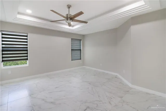 a bathroom with a granite countertop sink a mirror and shower