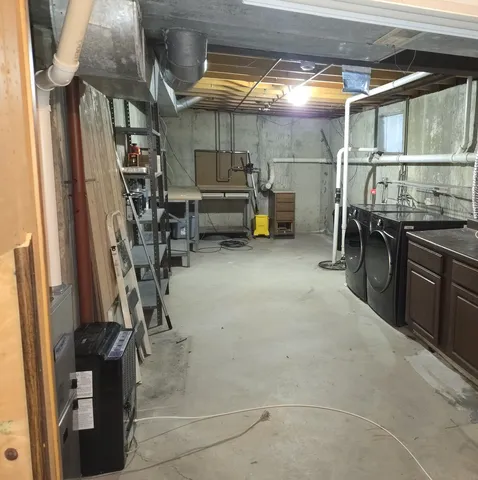 a view of a deck with large trees and wooden fence
