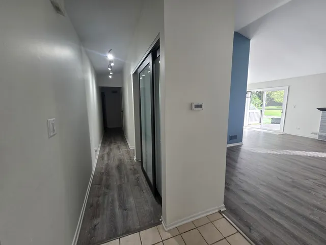 a view of hallway with wooden floor