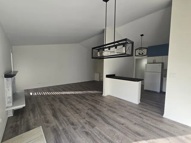 a view of a room with wooden floor