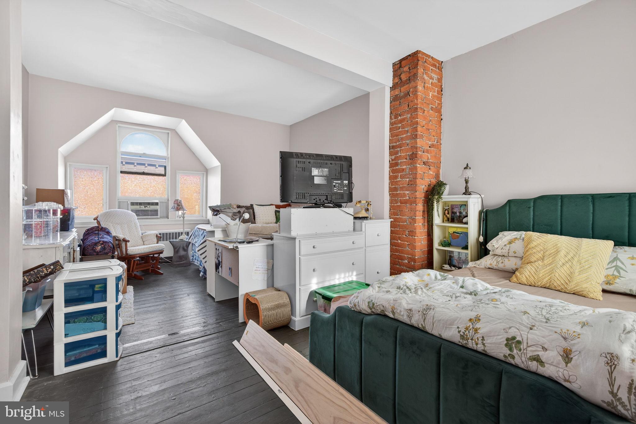 150 East Philadelphia Street York, PA 17401 - Photo 31 of 34 a bedroom with furniture a flat screen tv and a large window