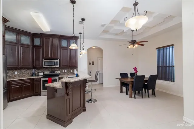 a bedroom with a bed and a ceiling fan