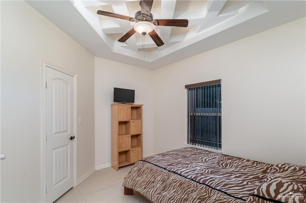 3210 South 5th Lane McAllen, TX 78503 - Photo 6 of 11 a bedroom with a bed and a ceiling fan