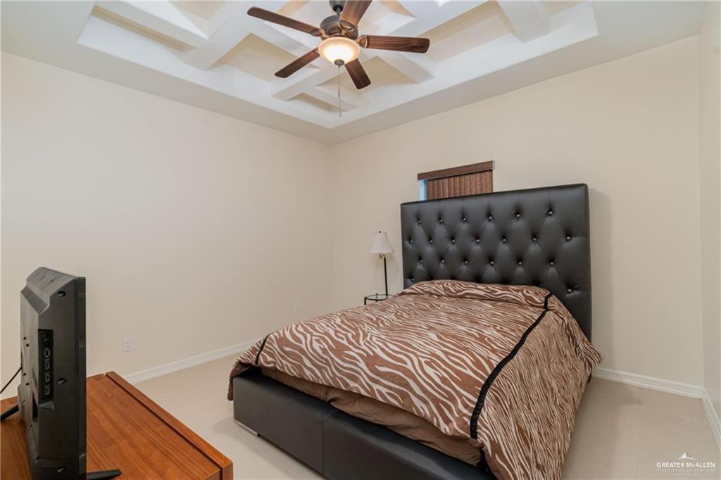 3210 South 5th Lane McAllen, TX 78503 - Photo 8 of 11 a bedroom with a bed and a ceiling fan