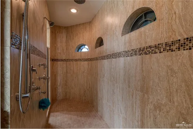 a view of a yard in front of a house with a large tree