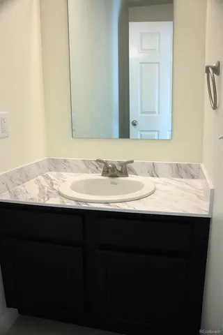 a bathroom with a sink and a mirror