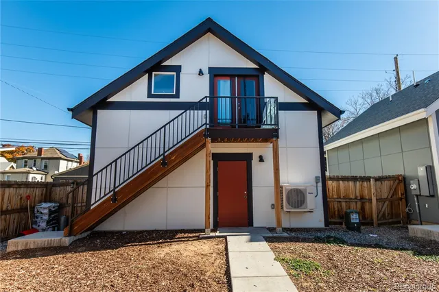a view of a house with wooden fence