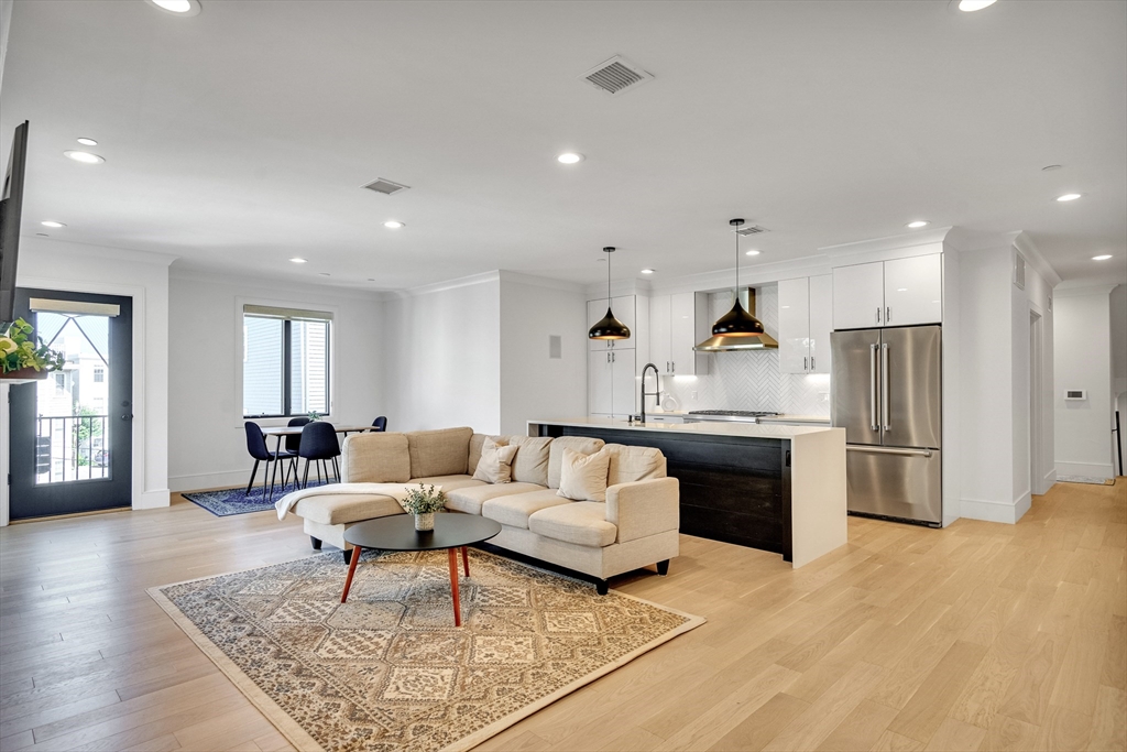 148 West 9th Street, Unit 6 Boston, MA 02127 - Photo 1 of 21 a living room with furniture and kitchen view